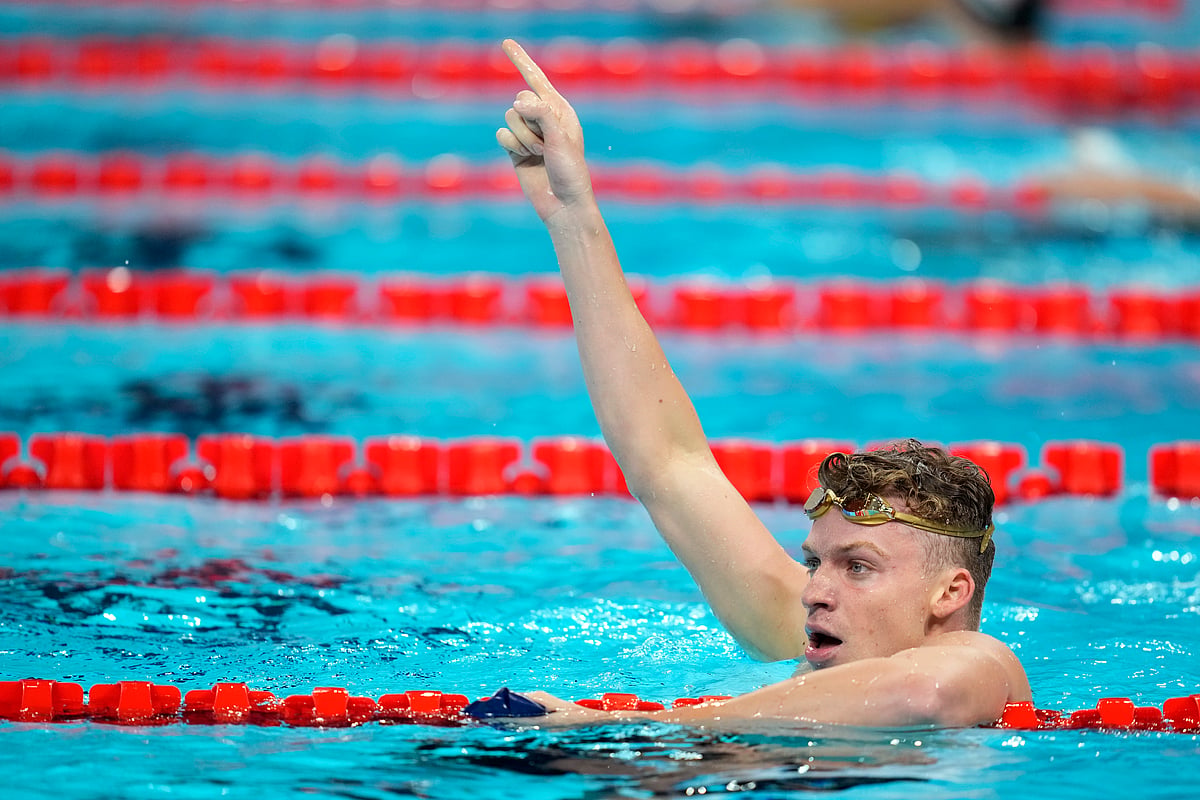 Leon Marchand, of France, celebrates after winning the men's 200-meter breaststroke final at the 2024 Summer Olympics, Wednesday, July 31, 2024, in Nanterre, France. -  (AP Photo/Ashley Landis)